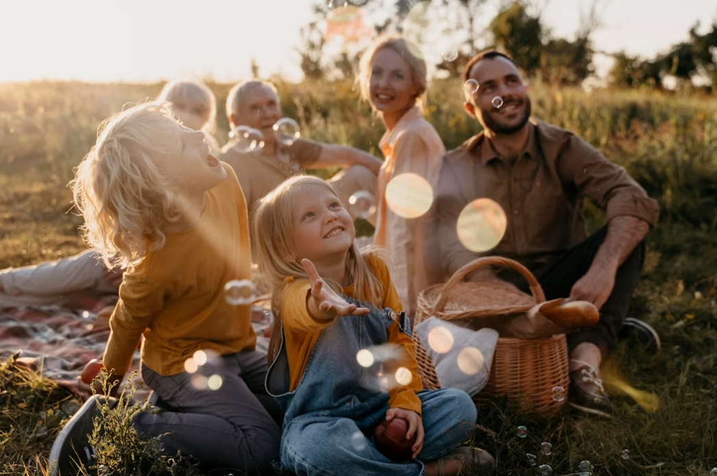 photo of happy family outdoors catching bubbles