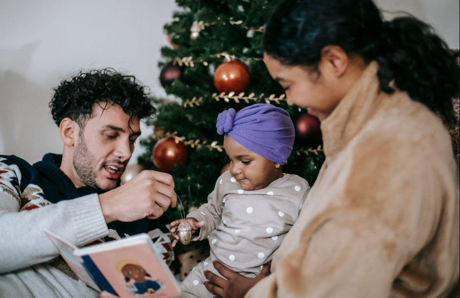 man, woman and child near the Christmas tree