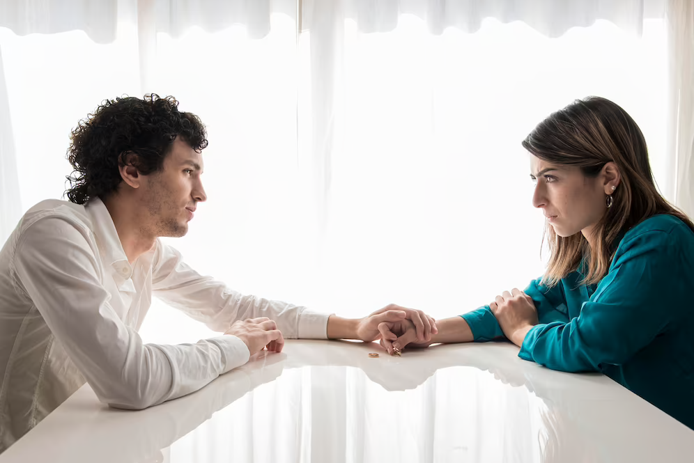 girl and guy sitting opposite each other