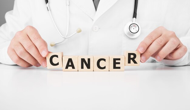 Doctor holding cubes with cancer inscription