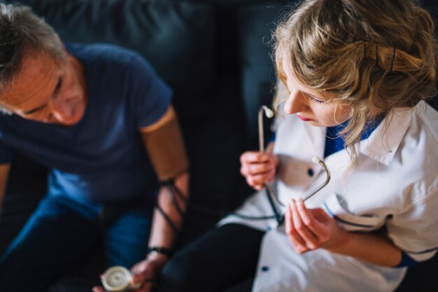 Nurse measuring a man's blood pressure