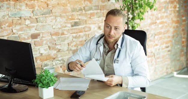 Doctor writes a prescription to a patient