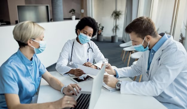 Doctor analyzing medical reports with his colleagues in the clinic